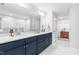 Bright bathroom with double vanity, marble floors, and large mirror at 1201 Canary Pepper Dr, Durham, NC 27713