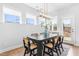 Bright dining room with a modern light fixture over a dark wood table and woven chairs at 1201 Canary Pepper Dr, Durham, NC 27713