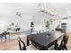 Bright open-concept dining room with modern chandelier and access to the living room and kitchen at 1201 Canary Pepper Dr, Durham, NC 27713