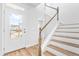Bright entryway showcasing a staircase with wooden handrail and wood-look flooring at 1201 Canary Pepper Dr, Durham, NC 27713
