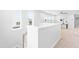 Upstairs hallway showcasing natural light and neutral decor leading to other rooms at 1201 Canary Pepper Dr, Durham, NC 27713