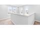 Bright hallway featuring multiple windows and white trim and railings at 1201 Canary Pepper Dr, Durham, NC 27713