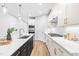 Bright kitchen with white cabinets, gold hardware, a gas range, and stainless steel appliances at 1201 Canary Pepper Dr, Durham, NC 27713