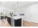 Spacious kitchen island with seating, stainless steel dishwasher, and views of the dining area at 1201 Canary Pepper Dr, Durham, NC 27713