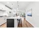 Modern kitchen with sleek white cabinets, stainless steel appliances, and an island with barstool seating at 1201 Canary Pepper Dr, Durham, NC 27713