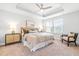 Bright main bedroom featuring a ceiling fan, natural light, and night stands at 1201 Canary Pepper Dr, Durham, NC 27713