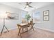 Bright home office featuring a wooden desk, neutral chair, decor, and two windows at 1201 Canary Pepper Dr, Durham, NC 27713