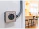 Close-up of a wall outlet with a glimpse of the open-concept kitchen in the background at 1201 Canary Pepper Dr, Durham, NC 27713