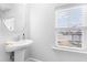 Clean powder room with pedestal sink and window letting in plenty of light at 1201 Canary Pepper Dr, Durham, NC 27713