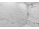 Walk-in shower with white marble tiles, built-in bench, and dual shower heads at 1201 Canary Pepper Dr, Durham, NC 27713