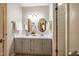 Bright bathroom featuring a double vanity with oval mirrors and white countertops at 121 Westview Dr # 106, Carrboro, NC 27510