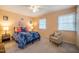 Cozy bedroom features plush carpet, natural light, and a stylish accent chair at 121 Westview Dr # 106, Carrboro, NC 27510
