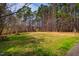 Expansive community common area with picnic tables surrounded by lush greenery at 121 Westview Dr # 106, Carrboro, NC 27510
