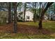 Exterior view of townhomes surrounded by mature trees, offering privacy and a peaceful setting at 121 Westview Dr # 106, Carrboro, NC 27510