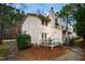 Exterior view of well-maintained two-story townhomes with private back patios and landscaping at 121 Westview Dr # 106, Carrboro, NC 27510