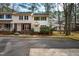 Charming two-story townhomes with green shutters, a well maintained lawn, and mature trees at 121 Westview Dr # 106, Carrboro, NC 27510
