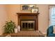 Traditional fireplace with brick surround, wooden mantle, and decorative accents creating a cozy atmosphere at 121 Westview Dr # 106, Carrboro, NC 27510