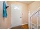 Welcoming front entry with wood floors, coat hooks, and staircase at 121 Westview Dr # 106, Carrboro, NC 27510