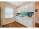 Galley kitchen with white cabinets and stainless sink, perfect for meal preparation at 121 Westview Dr # 106, Carrboro, NC 27510