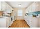 Well-lit kitchen featuring white cabinets and modern appliances at 121 Westview Dr # 106, Carrboro, NC 27510