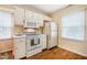 Well-lit kitchen featuring white cabinets and modern appliances at 121 Westview Dr # 106, Carrboro, NC 27510