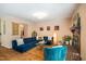Comfortable living room with stylish blue sofa, chair, hardwood floors, and fireplace, perfect for relaxation at 121 Westview Dr # 106, Carrboro, NC 27510