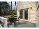 Outdoor patio with french doors to the home, with a table and chairs, and nature views at 121 Westview Dr # 106, Carrboro, NC 27510