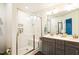 Modern bathroom featuring a glass-enclosed shower with built-in bench and double vanity at 124 Kipling Dr, Oxford, NC 27565