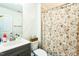 Bathroom with a single sink vanity, toilet, and shower with a floral curtain at 124 Kipling Dr, Oxford, NC 27565