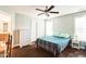 Comfortable bedroom with a ceiling fan and a view into the bathroom at 124 Kipling Dr, Oxford, NC 27565