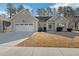 Charming single-story home featuring a two-car garage, landscaped front yard, and welcoming entrance at 124 Kipling Dr, Oxford, NC 27565