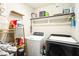 Functional laundry room equipped with modern washer and dryer units and storage shelves at 124 Kipling Dr, Oxford, NC 27565