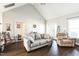 Bright living room featuring vaulted ceilings, wood floors, and comfortable seating at 124 Kipling Dr, Oxford, NC 27565