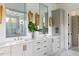 Bright bathroom featuring double sink vanity with white countertop, large mirror, and modern decor at 1421 Sky Vista Way, Raleigh, NC 27613