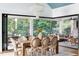 Beautiful dining room featuring a large table, chairs, and a stunning chandelier with views of the outdoor living space at 1421 Sky Vista Way, Raleigh, NC 27613