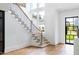 Bright foyer with hardwood floors, staircase, and natural light at 1421 Sky Vista Way, Raleigh, NC 27613