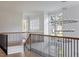 Bright foyer featuring wood and metal staircase and modern lighting fixture at 1421 Sky Vista Way, Raleigh, NC 27613