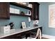 Stylish home office with built-in desk, dark cabinets, and ample shelving at 1421 Sky Vista Way, Raleigh, NC 27613