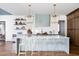 Stylish kitchen featuring a center island with bar seating, elegant pendant lighting, and modern appliances at 1421 Sky Vista Way, Raleigh, NC 27613