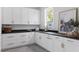 Laundry room with white cabinets, dark countertops, and ample storage space at 1421 Sky Vista Way, Raleigh, NC 27613