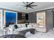 Spacious living room with a modern sectional sofa, wet bar, and sliding barn door at 1421 Sky Vista Way, Raleigh, NC 27613