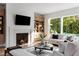 Bright and airy living room with fireplace and backyard views at 1421 Sky Vista Way, Raleigh, NC 27613