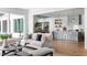 Bright living room showcasing the transition to kitchen and dining area with seamless hardwood flooring and ample natural light at 1421 Sky Vista Way, Raleigh, NC 27613