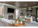 Inviting outdoor living area with a fireplace, TV, grill, and ample seating for entertaining guests at 1421 Sky Vista Way, Raleigh, NC 27613
