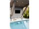 Luxurious pool with a swim-up bar, built-in seating, and an outdoor TV for ultimate relaxation at 1421 Sky Vista Way, Raleigh, NC 27613