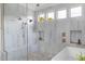 Modern shower with dual shower heads, bench seating, and windows for natural light at 1421 Sky Vista Way, Raleigh, NC 27613