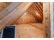 Unfinished attic space with exposed wooden beams and natural light at 1425 Princess Anne Rd, Cary, NC 27607