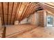 Unfinished attic with plywood flooring and exposed wooden beams at 1425 Princess Anne Rd, Cary, NC 27607
