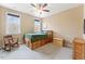 Bedroom featuring built-in storage beneath the bed, a rocking chair, and two windows at 1425 Princess Anne Rd, Cary, NC 27607