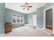 Bedroom featuring natural light, unique ceiling fan, and access to other rooms at 1425 Princess Anne Rd, Cary, NC 27607
